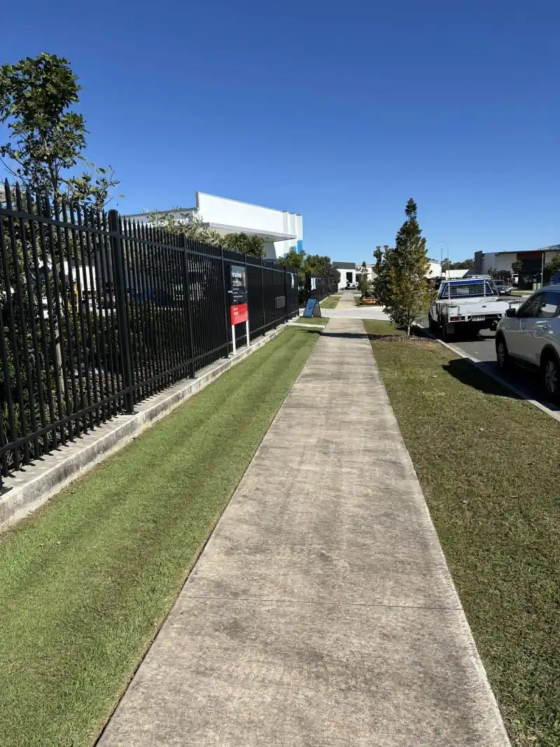 Crisp footpath edging after lawn mowing on a residential street in Strathpine