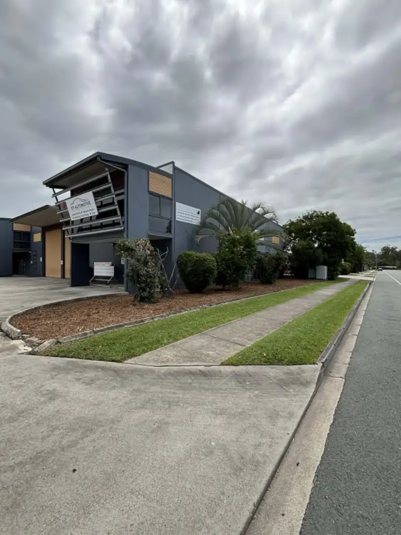 Mown lawn and tidy garden beds at a Moreton Bay business park on a garden maintenance round