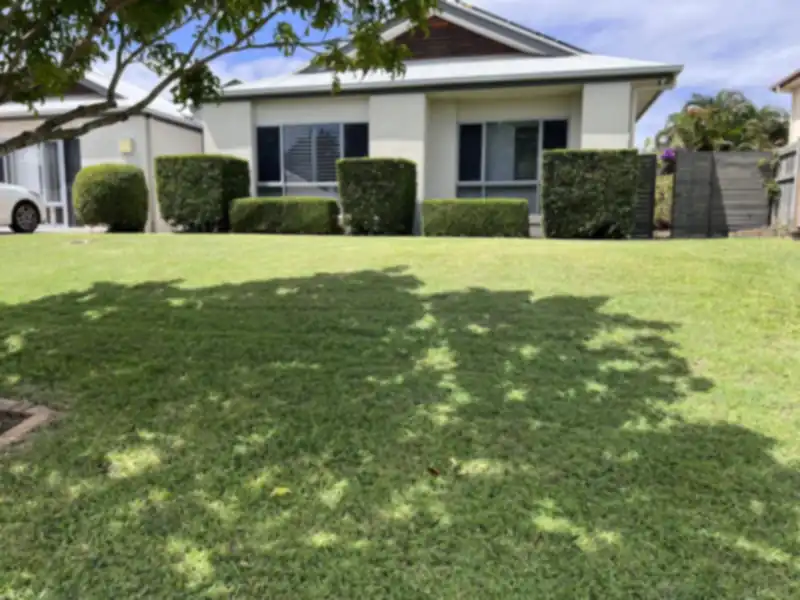 Freshly mown striped lawn in front of a Moreton Bay home after professional lawn mowing