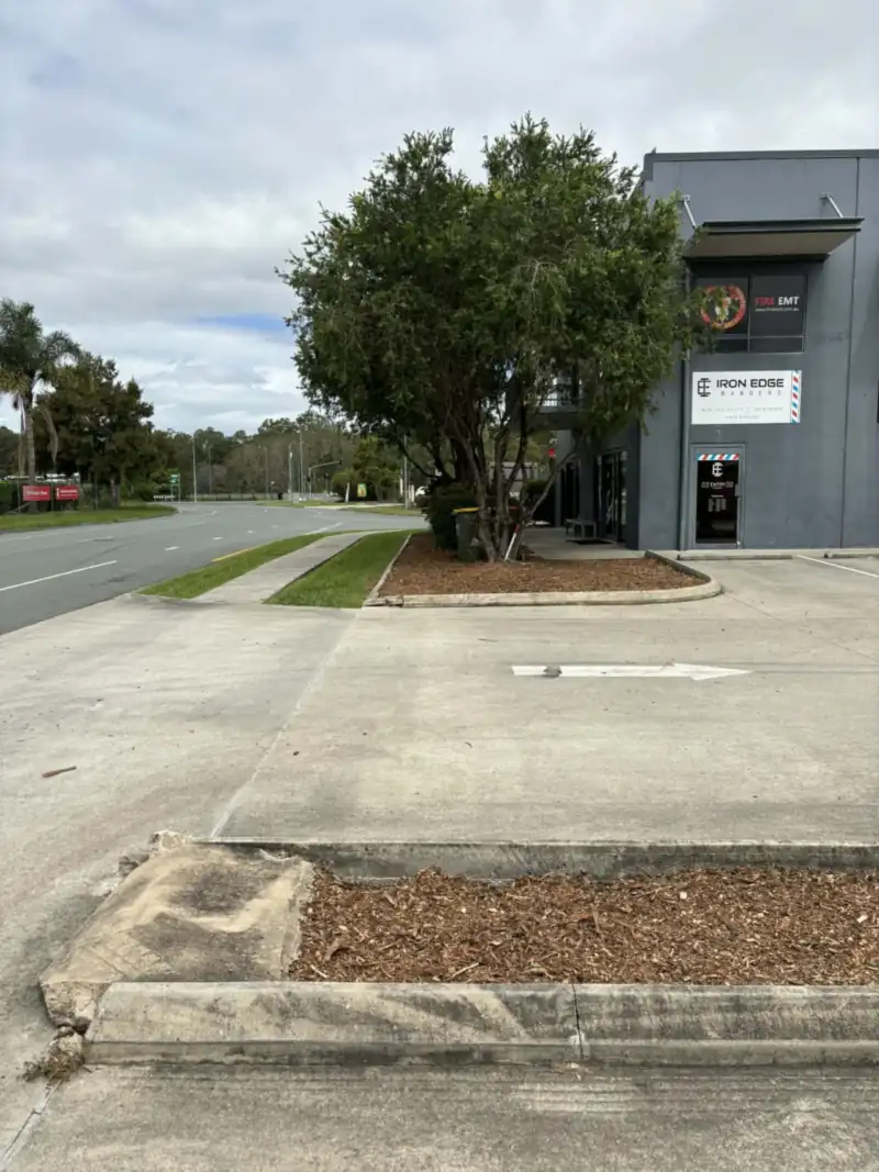 Freshly mulched garden bed along a fence line in Moreton Bay