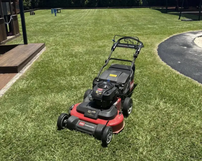 Lawn mowing Caboolture: push mower on a freshly cut residential lawn